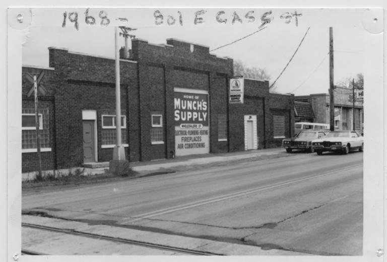 Black and white photograph of the Munch's Supply building on East Cass Street in 1968