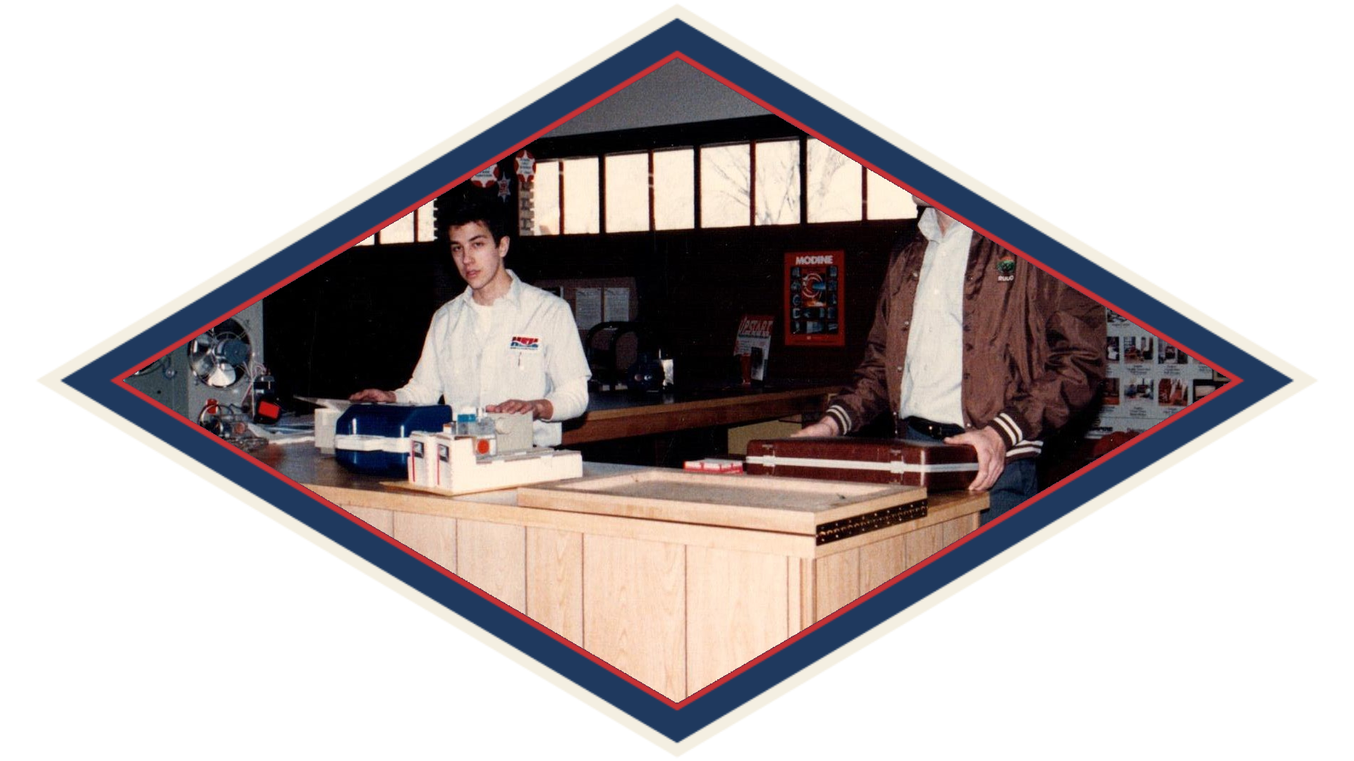 Two young men behind the parts counter in the 1980s