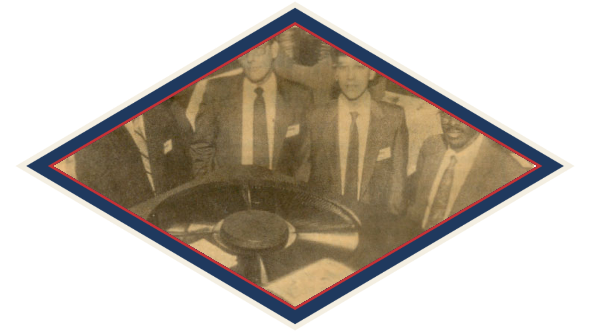Four men beside a condensing unit at a trade show